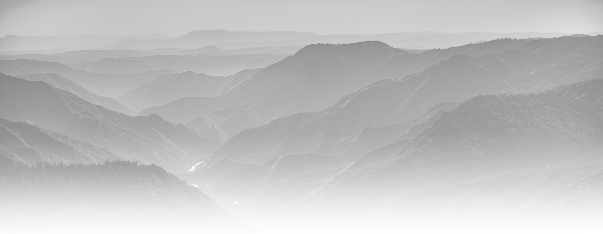 Grayscale faded landscape featuring a mountain view